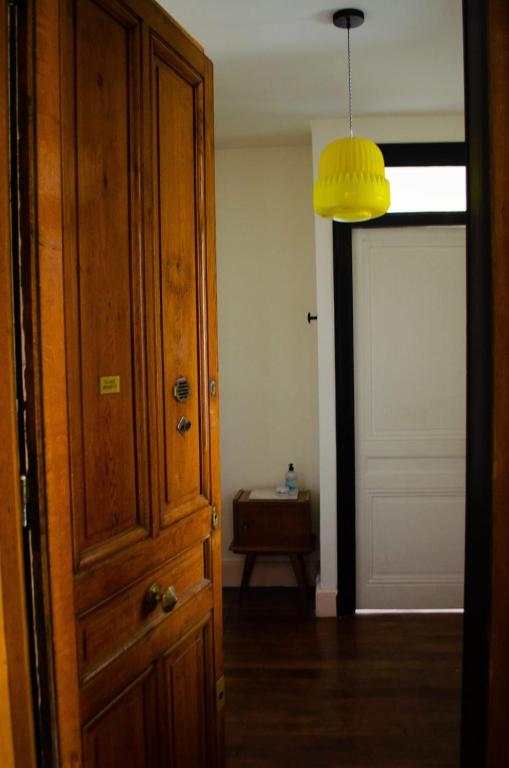 a room with a door and a yellow light at Chez Julie -métro Garibaldi- Université in Lyon