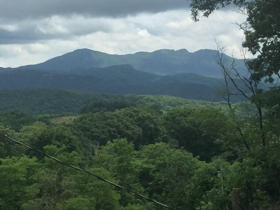a view of a forest with mountains in the background at KastleRock of the Highlands in Banner Elk