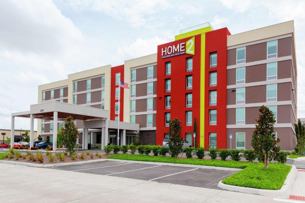 a hotel building with a home sign on it at Home2 Suites By Hilton Orlando South Park in Orlando