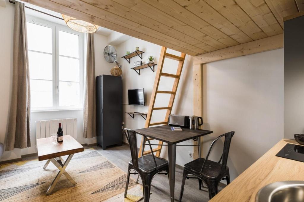 a tiny room with a table and chairs and a ladder at Joli 2 pers- Croix Rousse-Chartreux in Lyon