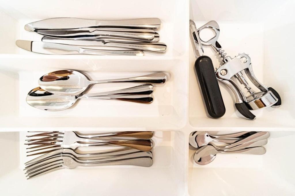 a drawer filled with silver utensils at Le petit Montel- studio avec garage-métro Valmy in Lyon