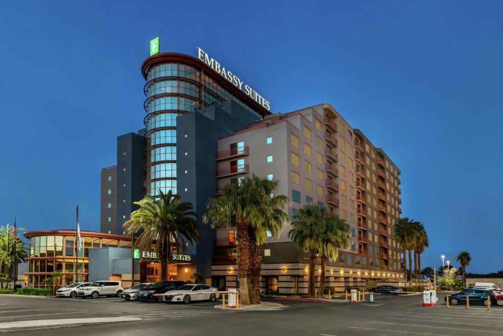 a building with cars parked in a parking lot at Embassy Suites by Hilton Convention Center Las Vegas in Las Vegas