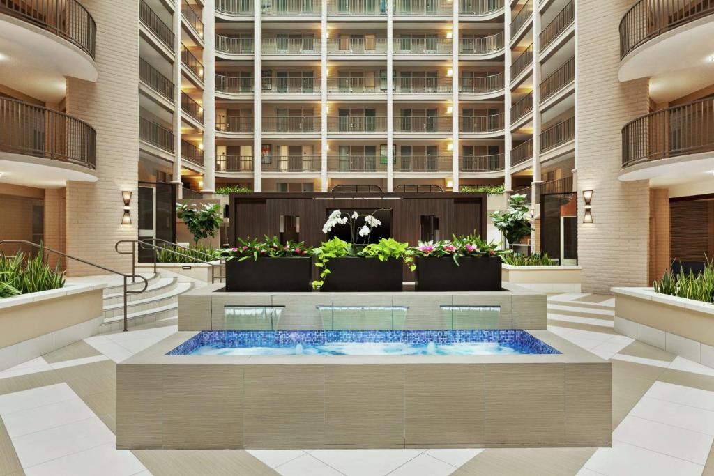 a hotel lobby with a hot tub and a large building at Embassy Suites by Hilton Arcadia-Pasadena Area in Arcadia