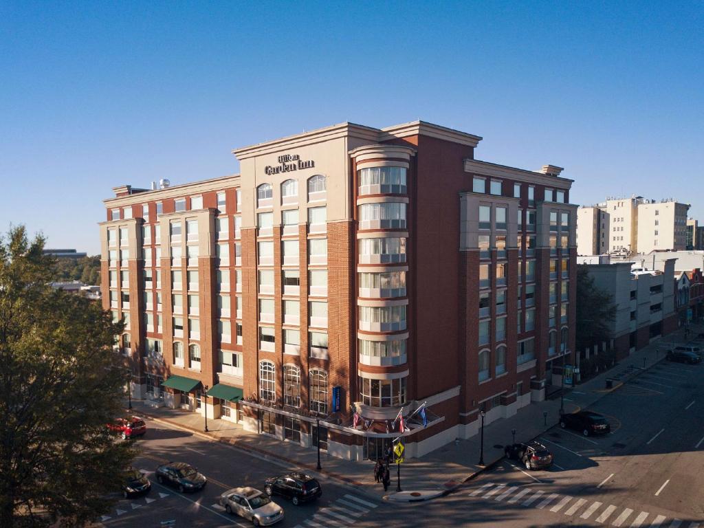 a large red brick building on a city street at Hilton Garden Inn Athens Downtown in Athens