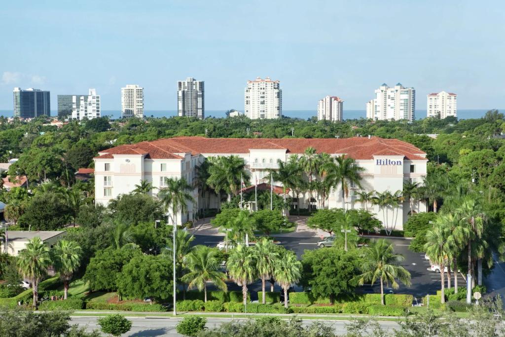 an aerial view of a hotel with palm trees at Hilton Naples in Naples