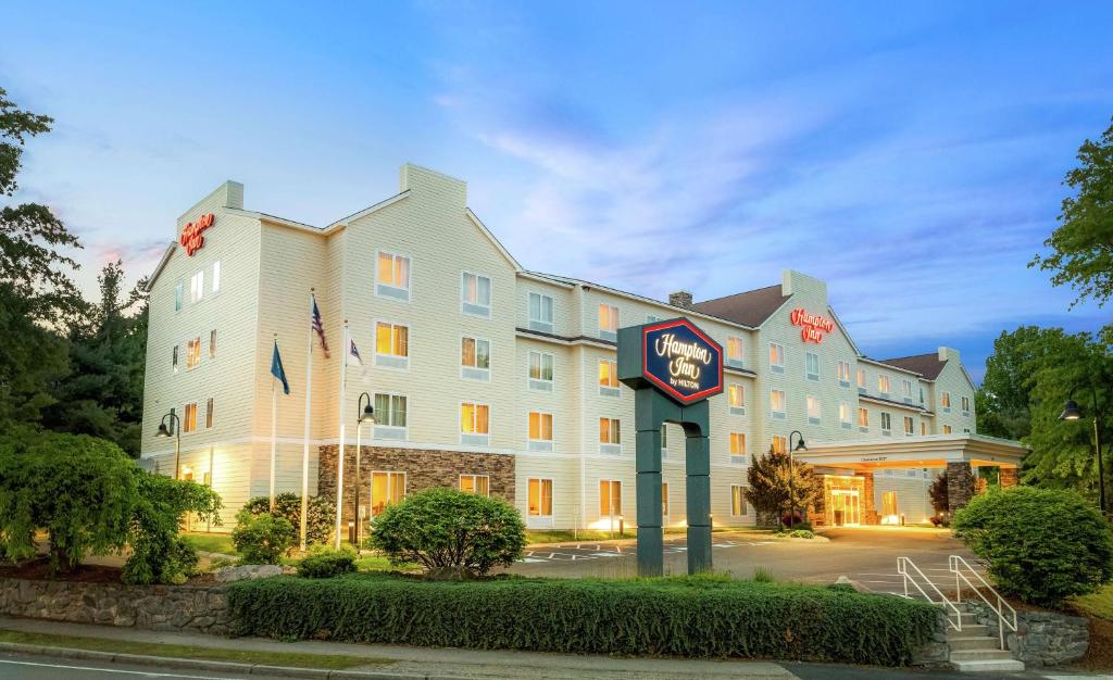 a hotel building with a clock in front of it at Hampton Inn Nashua in Nashua