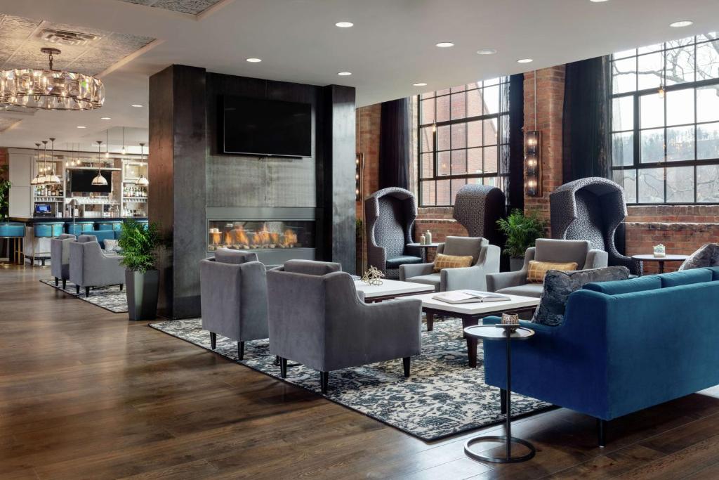 a lobby with couches and chairs and a fireplace at Foundry Hotel Asheville, Curio Collection By Hilton in Asheville