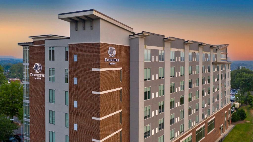 a rendering of a building with a sunset in the background at DoubleTree by Hilton Asheville Downtown in Asheville