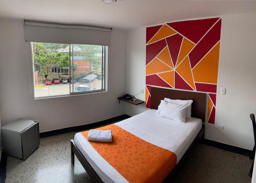 Un pat sau paturi într-o cameră la HOTEL RIVERA CENTRAL