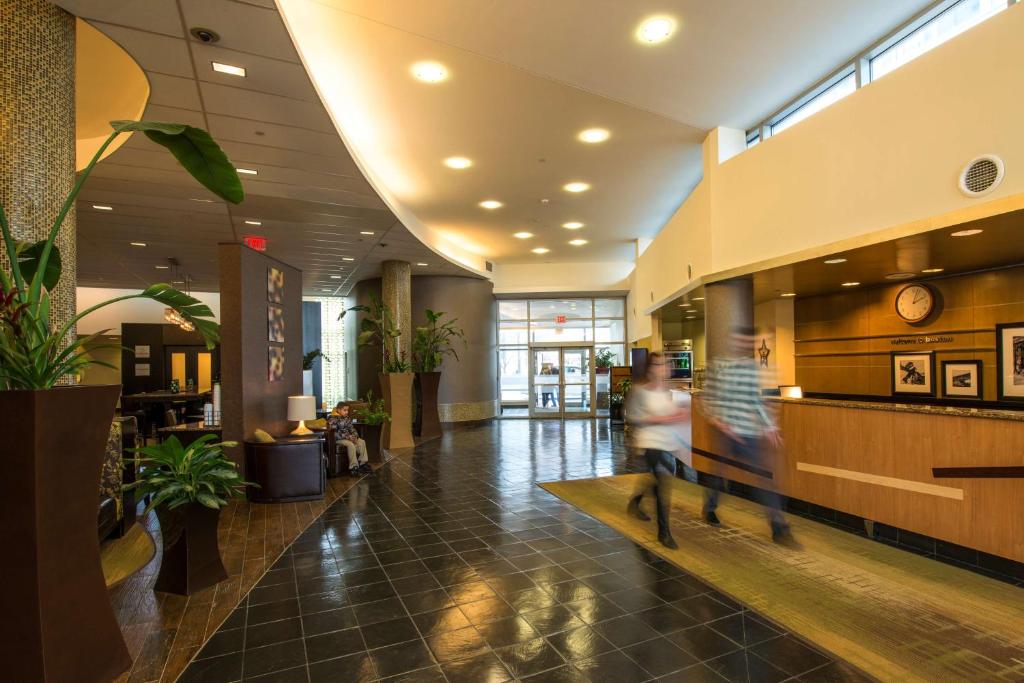 a couple of people walking through a lobby at Hampton Inn & Suites Boston Crosstown Center in Boston