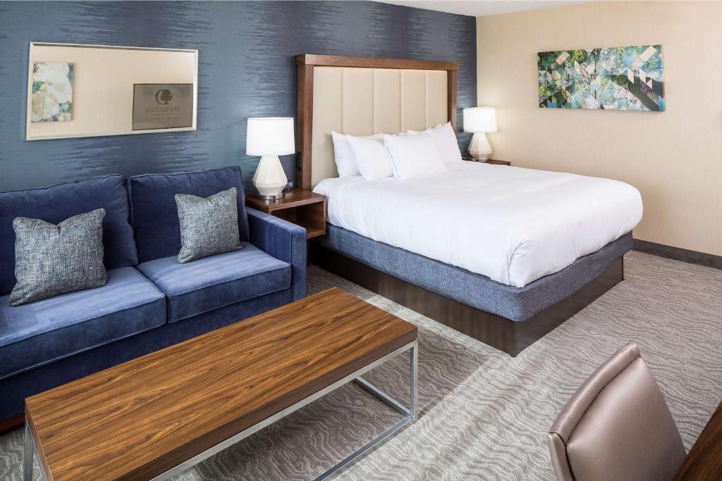 a hotel room with a bed and a couch at DoubleTree by Hilton Boston-Andover in Andover