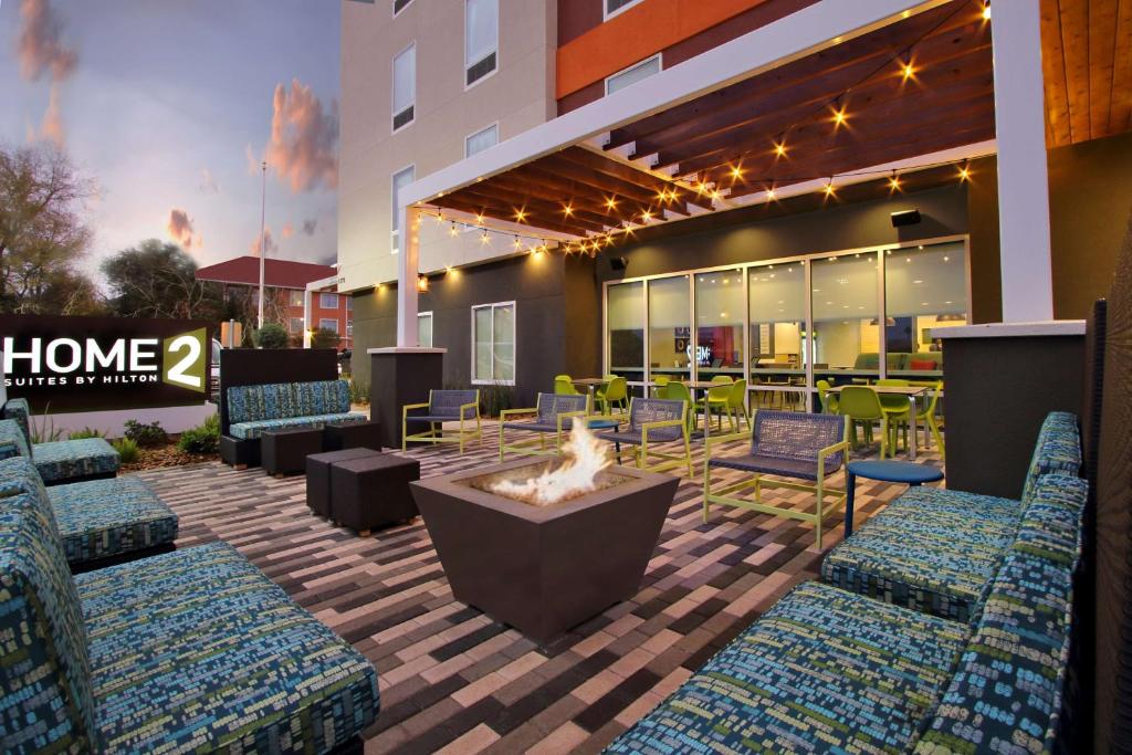 a patio with chairs and a fire pit in a building at Home2 Suites By Hilton Beaumont, Tx in Beaumont