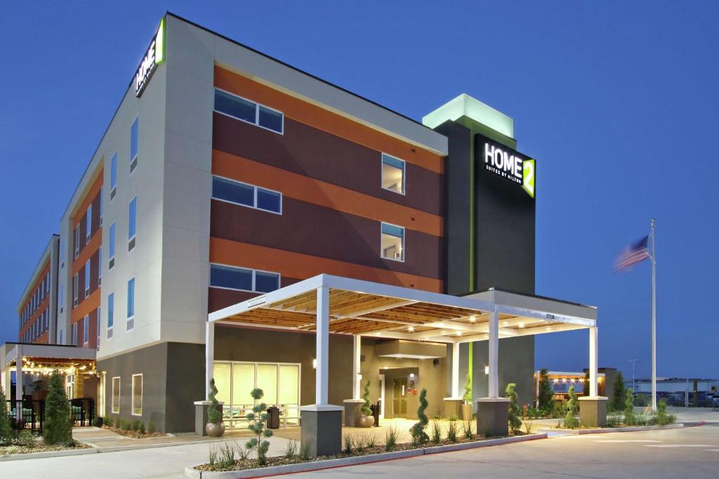 a hotel with a sign on the front of it at Home2 Suites By Hilton Port Arthur in Port Arthur