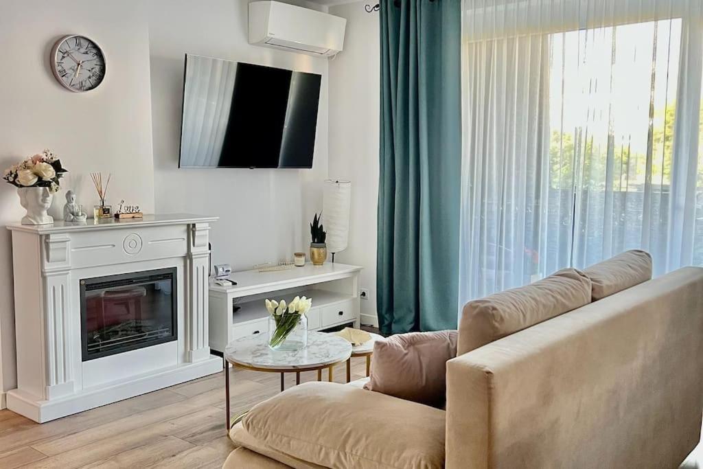 a living room with a couch and a fireplace at Apartament 3 camere in Baia Mare
