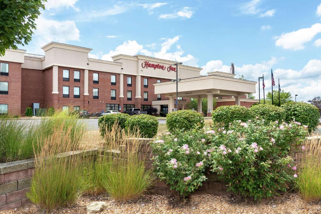 a building with a bunch of flowers in front of it at Hampton Inn Akron-South in Akron