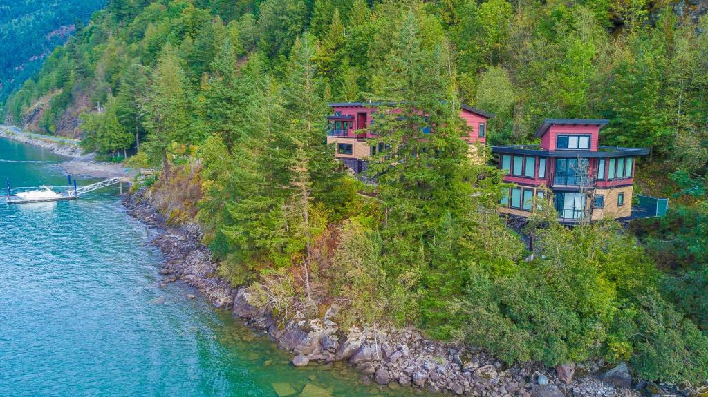 a group of houses on a hill next to the water at The Lodge on Harrison Lake in Harrison Hot Springs