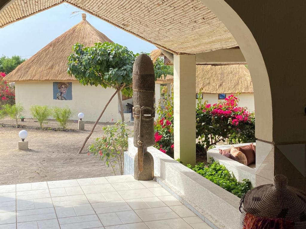 an entry to a house with a building with a tree at Toubacouta Lodges in Toubakouta