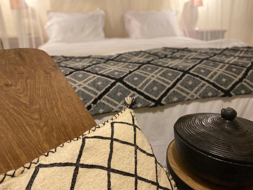 a bedroom with a bed and a hat on a table at Toubacouta Lodges in Toubakouta