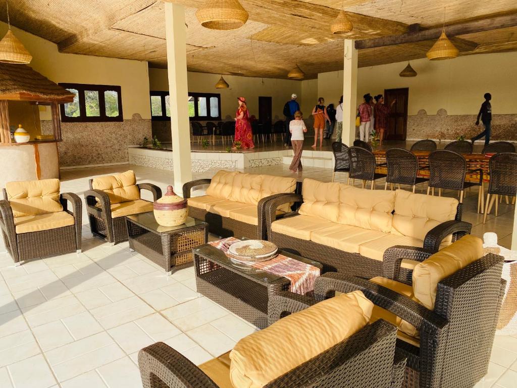 a living room with couches and chairs and a table at Toubacouta Lodges in Toubakouta