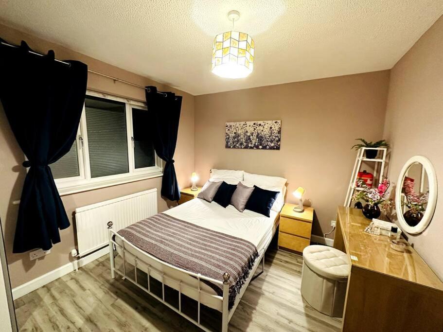 een kleine slaapkamer met een bed en een raam bij NKN cosy maisonette close to train station, food, shopping in Kent