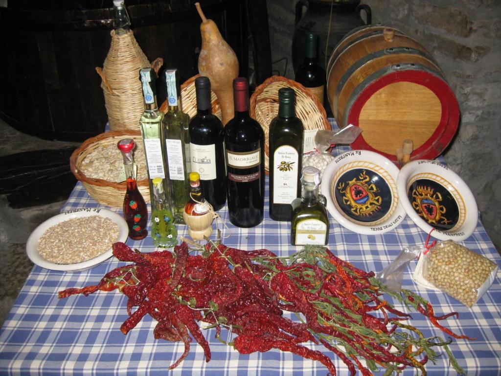 a table with bottles of wine and a crab on it at Il Molino Della Contessa in Castelmezzano
