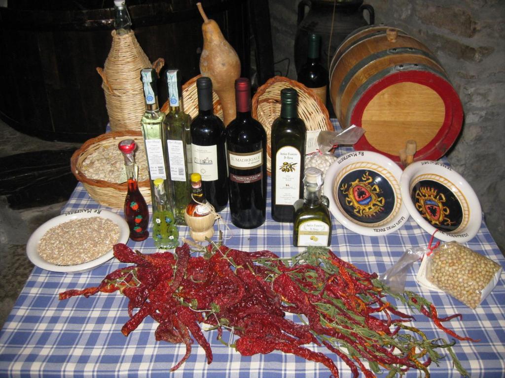 una mesa con botellas de vino y un cangrejo. en Il Molino Della Contessa, en Castelmezzano