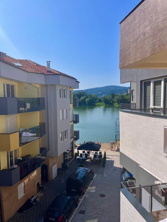 a view of a river between two buildings at Azzurro Apartman Srebrno Jezero in Veliko Gradište
