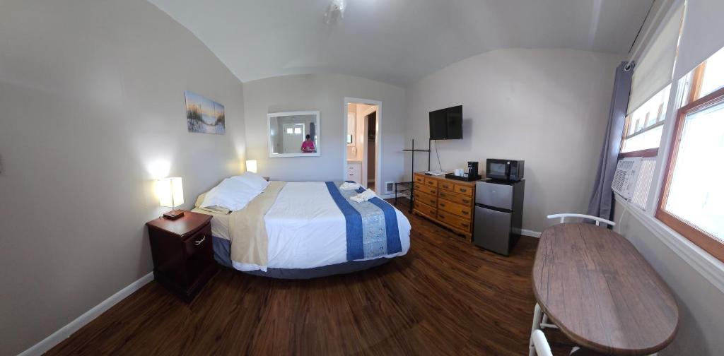 - une chambre avec un lit et une table dans l'établissement Lake Shore Farm Inn, à Northwood