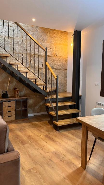 a living room with a staircase and a table at A de Juan - Tres Marias Apartments in Redondela
