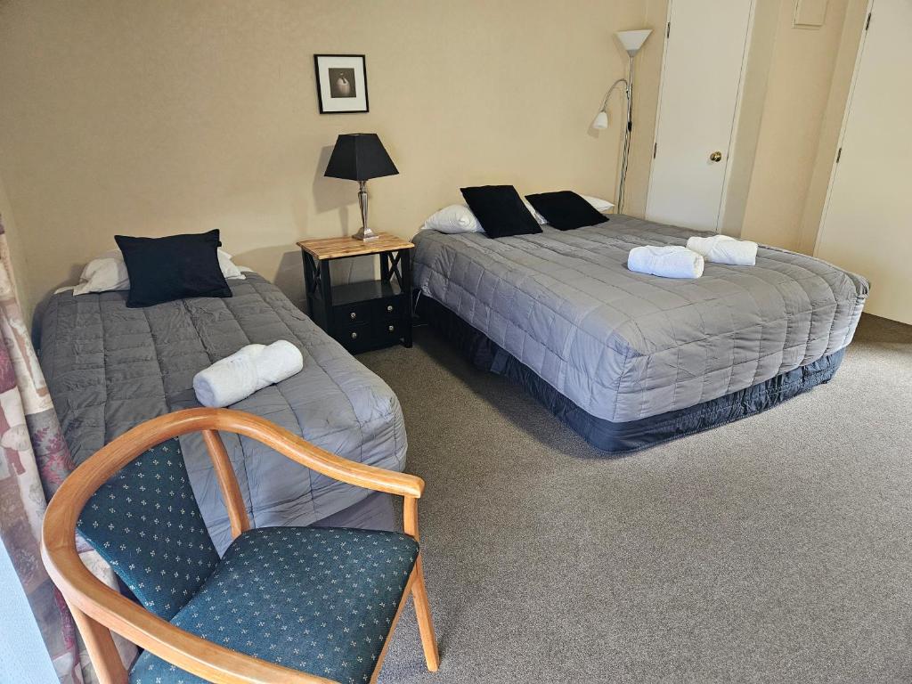 Postel nebo postele na pokoji v ubytování Kiwi Park Motels