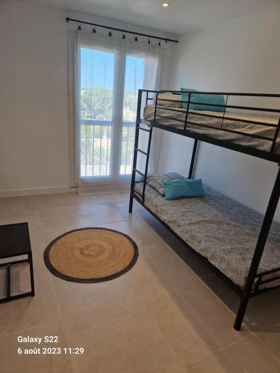 a room with two bunk beds and a window at CHEZ LALLA in Marseille