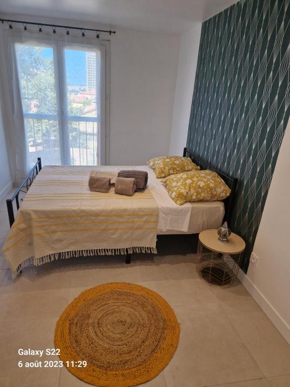 a bedroom with a bed and a large window at CHEZ LALLA in Marseille