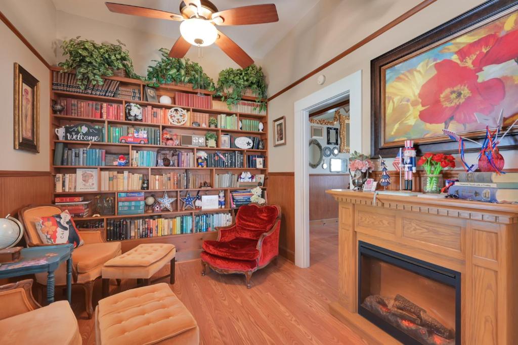 a living room with a fireplace and book shelves at Spacious Downtown Jackson Retreat- Historic Hangout in Jackson