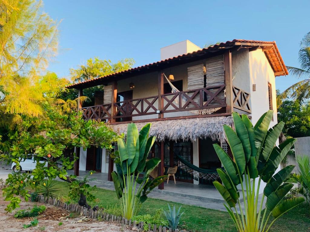 a resort building with a thatched roof at Vila Viva in Barra Grande