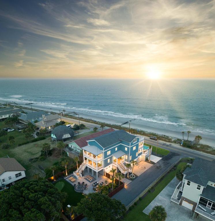 an aerial view of a house and the ocean at Beachfront Pool Outdoor Kitchen Firepit Putting Green in Folly Beach