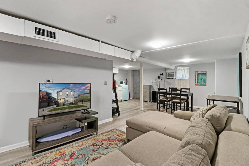 sala de estar con sofá y TV de pantalla plana en Cozy North Side Oasis, en Chicago