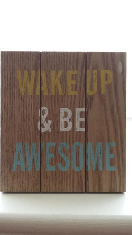 a wooden sign with the words wake up and be awesome at The Railway Inn Westerfield in Ipswich
