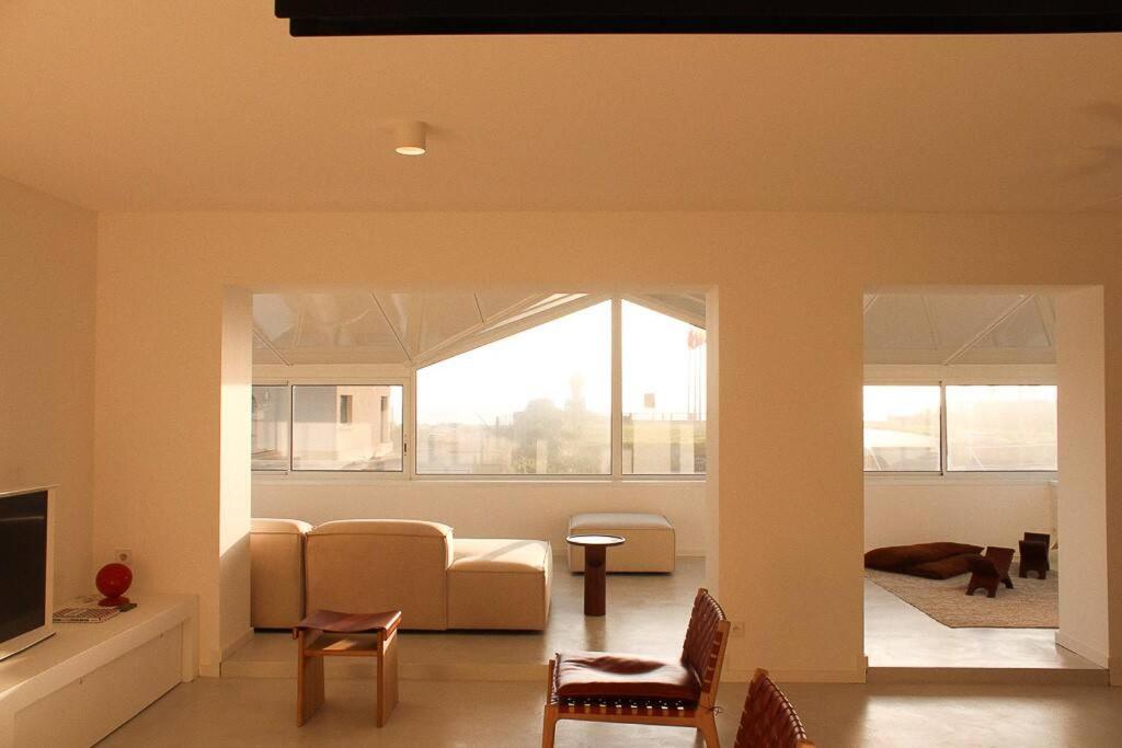 a living room with a couch and a tv at Mimizan Blue - Laid back luxury on the beach in Mimizan