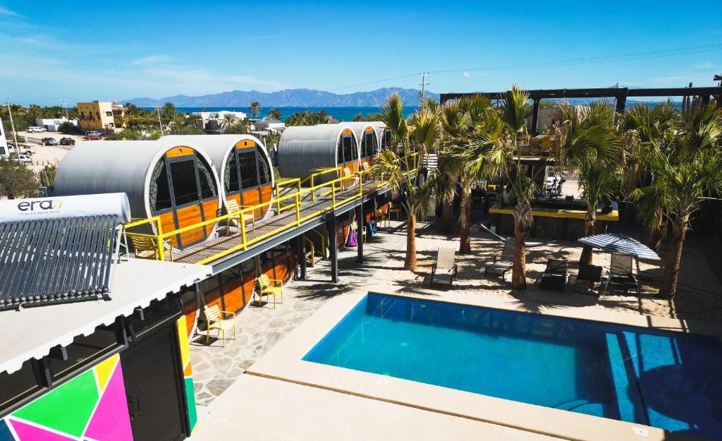 a resort with a swimming pool and a train on a roof at ChangoMango in La Ventana