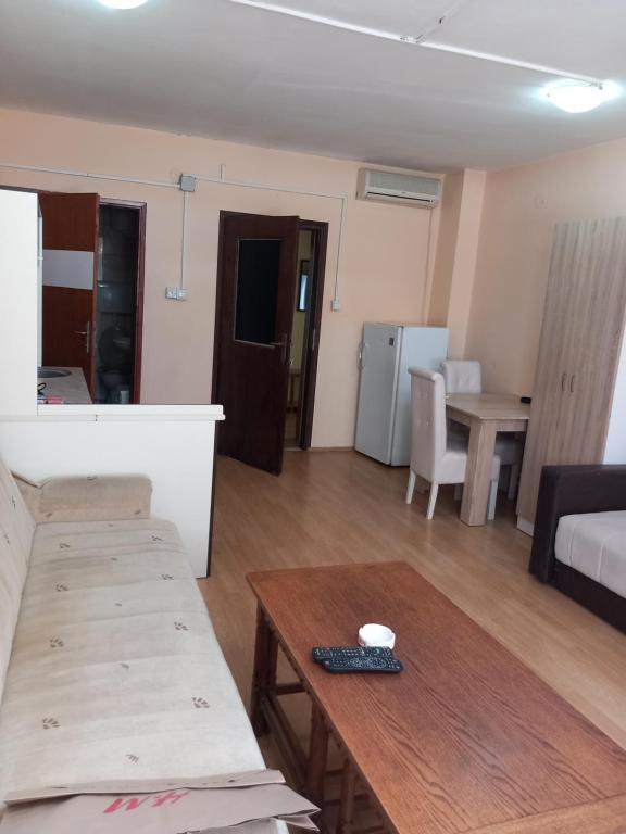 a living room with a table and a couch at Apartmani M-1 in Novi Sad