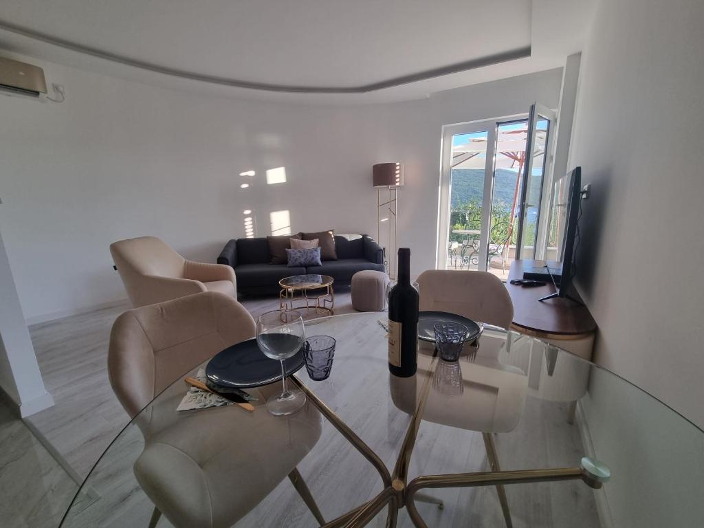 a living room with a glass table and chairs at Kumbor, Herceg Novi in Kumbor