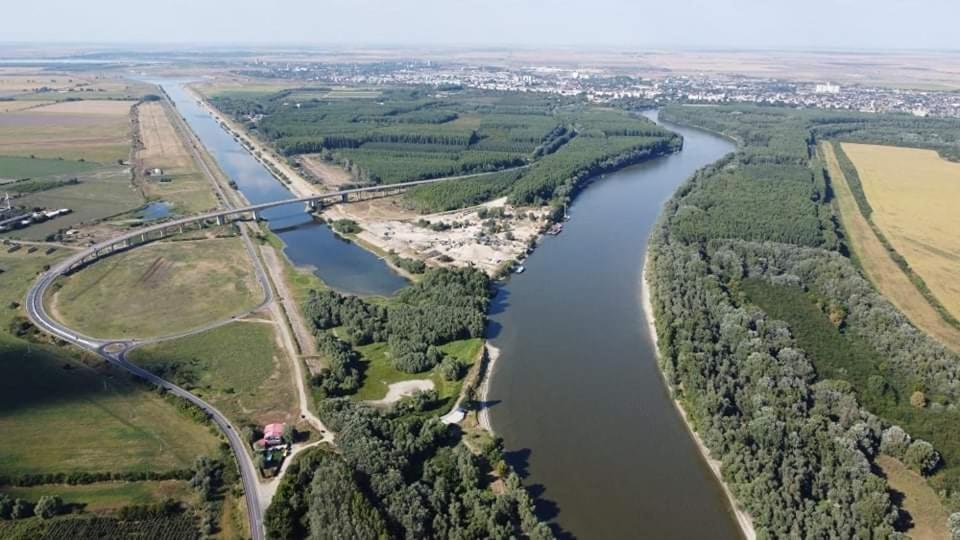 an aerial view of a river and a bridge at Casa Carp Calarasi in Călăraşi