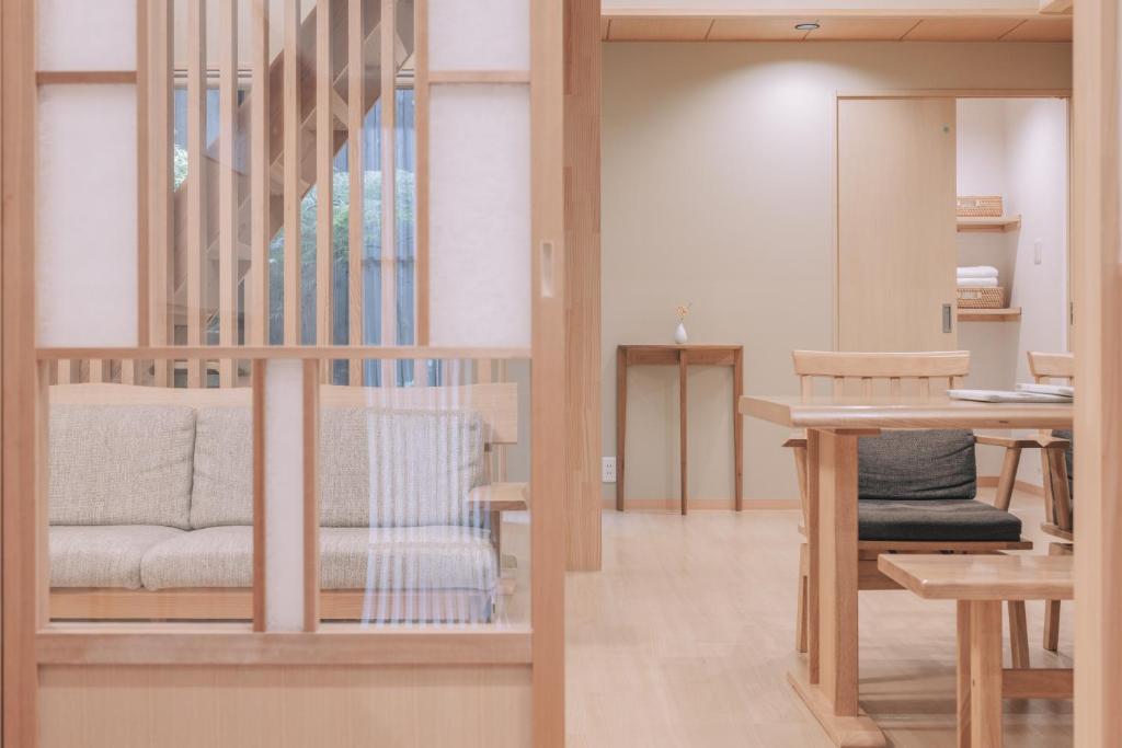 a living room with a staircase and a table at 櫛笥ノ家 Machiya Kushige in Kyoto