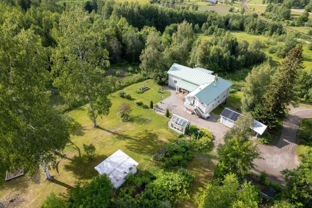 an aerial view of a barn with a blue roof at Big house with jacuzzi by the forrest in Hudiksvall