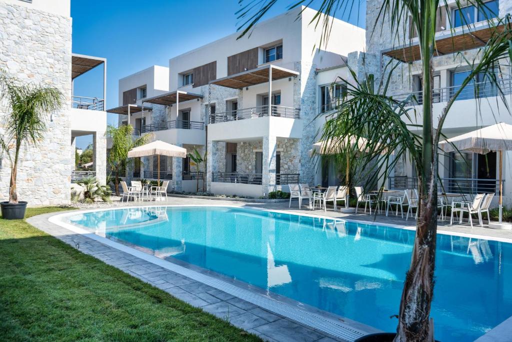 an image of a swimming pool in front of a building at THALASSIA LUXURY APARTMENTS in Stavros