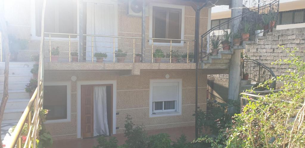 an apartment building with a balcony and a staircase at Hills Villa in Vlorë