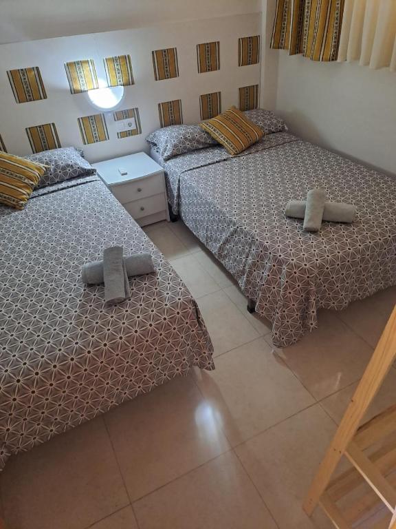 Postel nebo postele na pokoji v ubytování PALMAVERA BEACH
