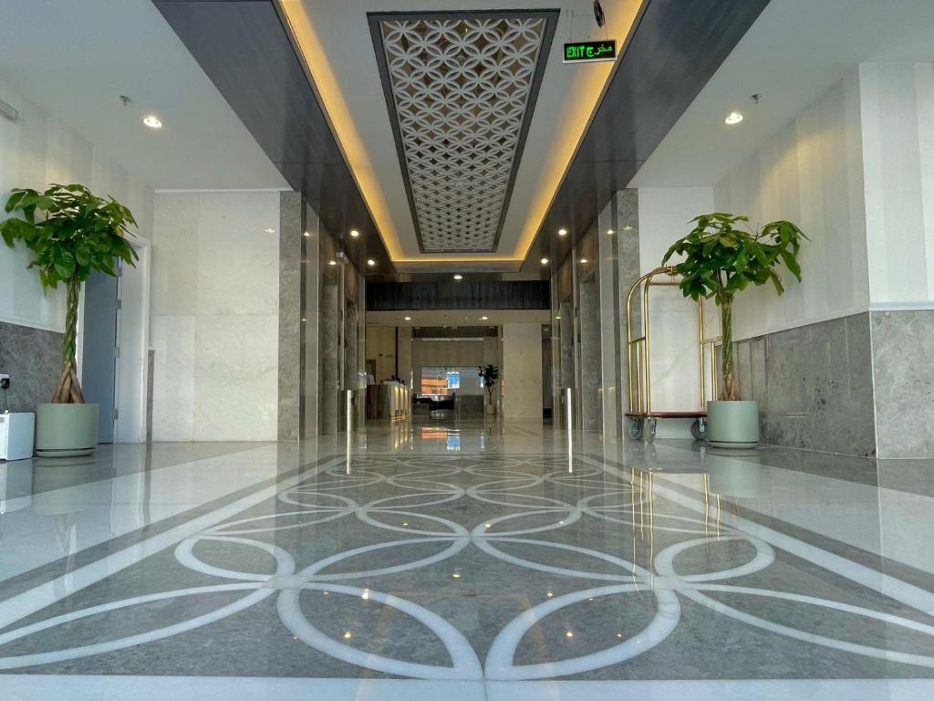 a hallway with a lobby with palm trees in it at فندق بلينسية Balensia Hotel in Medina