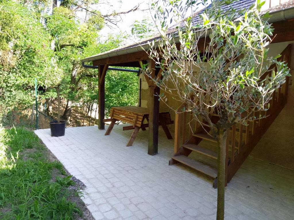 a pavilion with a bench and a stairs to a porch at Logement du Coteau entre Beauval et Amboise in Faverolles-sur-Cher