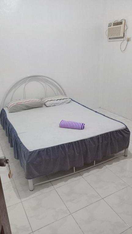 a bed in a room with a mattressvisor at French House 2 in Moalboal